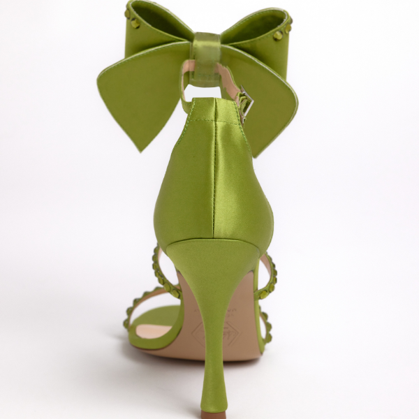 Artisan-crafted green heels with customizable bow
